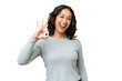 © luismolinero - Young Argentinian woman over isolated background showing ok sign with fingers
