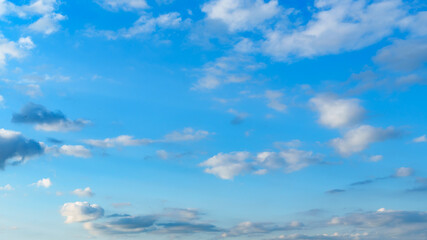 Wall Mural - beautiful blue sky with soft white clouds at dawn for an abstract background