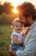 © miss irine - Happy baby smiles as father kisses forehead outdoors. Golden sunset light illuminates father holding little child. Warm bond shown in this family moment.