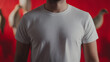 © photo for everything - Man in a casual white t-shirt against a vibrant red backdrop featuring decorative objects; the focus on simple attire and bold color creating a stylish image.