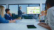 © Videophilia - Senior businessman presenting financial charts and data on a large screen to a diverse team in a modern conference room, collaborating on strategy, planning, and analysis