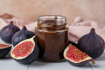 Wall Mural - Jar of sweet fig jam on white tile table against beige wall