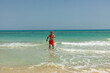 © travelview - attractive senior man at the beautiful sandy beach in swim suit