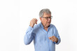 © travelview - sixty years old man with blue shirt inserting his hearing aid