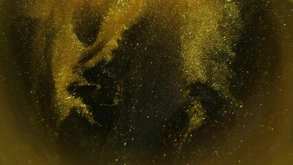 Wall Mural - Shimmer texture. Blur golden ink. Defocused yellow color glitter pigment sparkling water spilling on abstract dark black background.