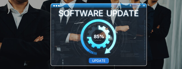 Wall Mural - Group of business professionals focus on a software update displayed on a computer screen, highlighting collaboration and progress in a modern office environment. Trope