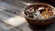 © Vitalii - Basket of mushrooms on a wooden table. the basket is made of woven straw and is filled with different types of mushrooms.