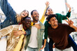 © Xavier Lorenzo - Diverse millennial friends are gathered outdoors in the city, smiling and taking pictures while sharing laughter and positive energy. Friendship, fun, and urban lifestyle concept