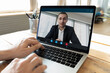 © fizkes - Closeup businessman talking to partner on video call using notebook