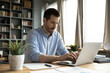 © fizkes - Focused millennial business specialist typing on notebook at workplace desk