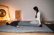 © phoenix021 - Masseuse performing Thai yoga massage , resting guiding and relaxing , laying on the back on mattress