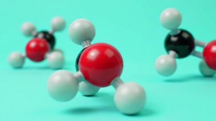 Molecular Structures with Red Black and White Atoms on Turquoise Background