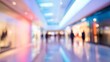 © Pixel - A blurred indoor scene in a modern shopping mall with dreamy artificial lighting, polished floors reflecting lights,