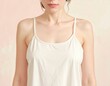 © AiMaball - Woman wearing white silk camisole tank top showcasing minimalist elegant sleepwear and intimate apparel design