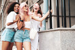 © halayalex - Three young beautiful smiling hipster female in trendy summer clothes.Sexy carefree multiracial women posing on the street background.Positive models having fun in sunglasses