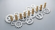 © RISKI - Wooden figures on gears symbolize team synergy and business workflow efficiency