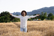 © Westend61 - Man expressing gratitude with open arms in wheat field outdoors