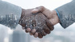 © Volodymyr Shcherbak - Closeup of two businessmen shaking hands with digital circuit overlay and city skyline background, symbolizing technology