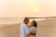 © CandyRetriever  - Happy Asian family senior couple dancing on the beach at sunset. Healthy elderly husband and wife enjoy outdoor lifestyle travel nature at the sea in summer. Old people mental health wellness
