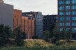 © yaqui_villegas - Contemporary architecture in Hamburg combining preserved brick industrial buildings with new glass towers and grassy urban foregrounds under soft evening light