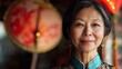 © Sunny - Asian woman wearing traditional attire stands confidently, showcasing intricate patterns and vibrant colors, with decorative lanterns and cultural elements in the background, embodying heritage and pr