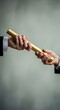 © MdNazim - Golden baton exchange between hands handover passing