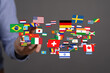 © vegefox.com - A hand reaching towards flags of different nations, symbolizing global connections, international relations, and worldwide unity. Perfect for pr