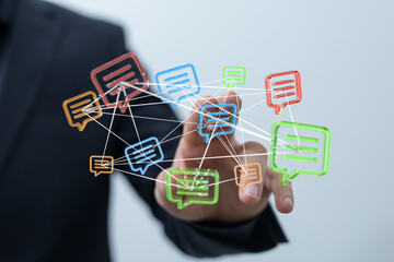 A business professional touching a digital network of speech bubbles, representing online communication, social media, and information sharing.