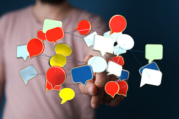Man's hand showing a network of floating speech bubbles. Social network and digital communication concept. Communication, connection, technology