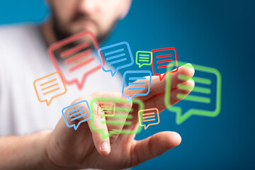 Hand interacting with glowing message icons. Represents communication, digital dialogue, interaction, and innovative tech solutions.