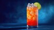 © Rahmat - A tall, refreshing cocktail with a vibrant orange hue, ice cubes, and a lime garnish