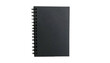 © Adnan - A black rectangular notepad with a spiral binding on a solid black background, top-down view