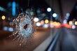 © Farah - Close-up of shattered glass with a hole, bokeh lights of traffic in background at night