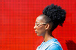 © ADDICTIVE STOCK - Profile of a woman against a vibrant red wall