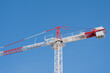 © ADDICTIVE STOCK - Tower crane against a blue sky in construction site