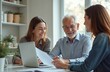 © Vadym - Female real estate agent consulting senior couple about mortgage rent looking at laptop screen. Elderly family wife, husband listen to financial advisor broker. People discussing documents at meeting