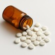 © Людмила Денисова - White pills spilling from amber bottle on white background