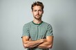 © Vadym - Portrait of young handsome man in striped shirt with crossed arms. Guy looking at camera on grey studio background. Adult person shows confidence, style and fashion in casual wear. One male.
