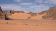 © TKalinovskaya - A trip to Sahara desert in Algeria. Beautiful african travel photo. Sandy landscapes, mountains, rocks,dunes, and nature. Summer vacation in arab country.
