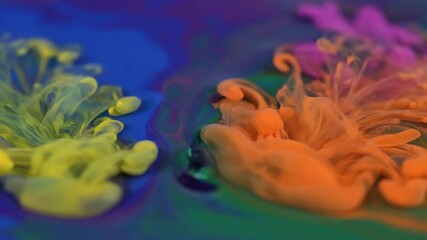 Wall Mural - macro close-up of vibrant colorful liquid ink flowing and mixing in a clear viscous solution, creati