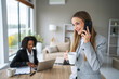 © Miljan Živković - Businesswoman laughing during phone call, enjoying coffee break