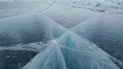 Wall Mural - Seamlessly looping abstract pattern of slowly shifting glacial ice with deep, elegant cracks and subtle movement pristine, texture, shifting