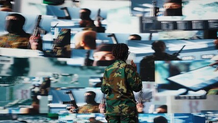 Military commander in war communicating enemy activity to troops, following them using videowall. Military dispatcher wearing headset speaking about enemy threats seen on digital display, camera A