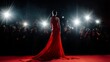 © InfiniteStudio - Elegant woman in red gown poses for photographers at a glamorous event under bright lights