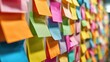 © Pixelzone - Stunning photo of colorful sticky notes covering a wall in a closeup shot.