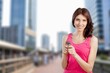 © BillionPhotos.com - Happy woman using smartphone walking in city
