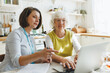 © shurkin_son - Senior lady with gray hair learning how to use laptop and applications for bank transactions, ordering groceries, medications from pharmacy or making appointment online to visit doctor