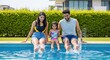 © PRASANNAPIX - Happy Indian Family Splashing Water in Swimming Pool