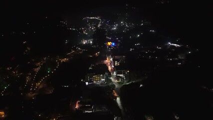 Wall Mural - Aerial view overlooking the illuminated streets of Munnar, night in Kerala, India