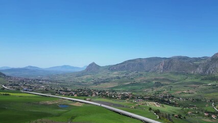 Wall Mural - Aerial drone footage of the Sicilian countryside: winding roads, green fields, and mountain landscapes under bright Mediterranean light. Ideal for travel, nature, and adventure projects.